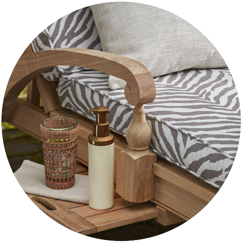 bottle of lotion next to outdoor chaise